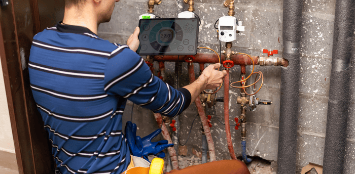 Plumber inspecting pipes Alabaster AL repaired backflow testing