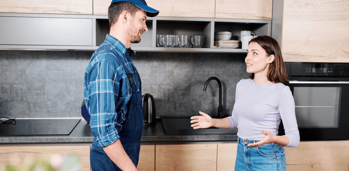 Plumber talking to customer Plumber talking to customer